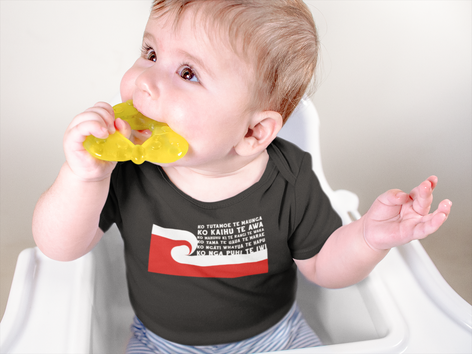 cute baby sitting in high chair wearing a custom pepeha onsie